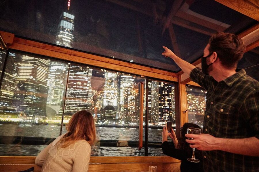 NYC: City Lights Yacht Cruise with Drink Included - The boat experience: 1920s décor, climate control, and assigned comfort