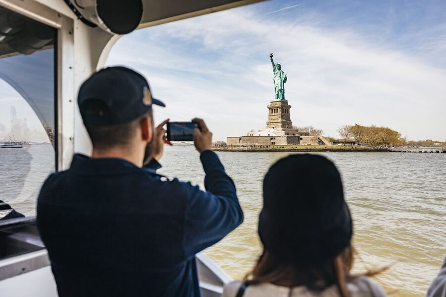 NYC: Wall Street Tour with 9/11 Memorial and Statue Ferry - Battery Park and the Canyon of Heroes, walking the parade route vibe